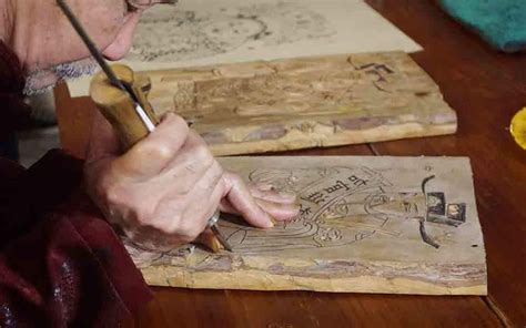 A Chinese Artist Carvesa Woodblock In His Workshop To Make Woodcut New