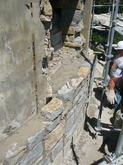 Stone Wall In The Process Of Being Restored By Advanced Masonry