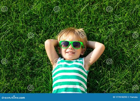 Happy Child Lying On Spring Green Grass Stock Image Image Of Portrait