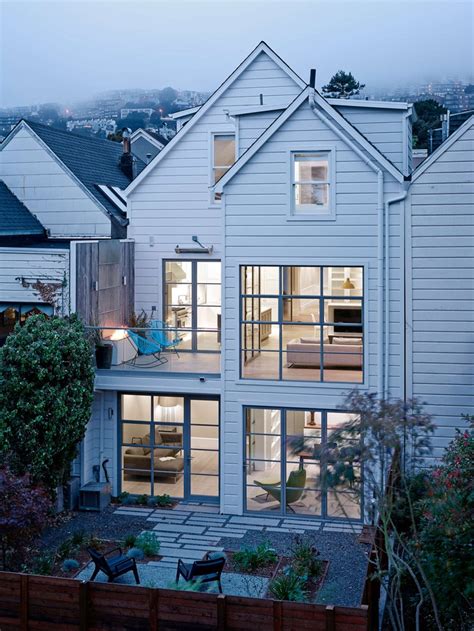 The modern kitchen features corian counter top and stainless steel appliances with a gas stove. A Contemporary Remodel Of A Victorian Home In San ...