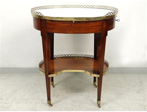 A dramatic yet refined contemporary piece. Coffee table oval Louis XVI mahogany white marble gilded ...
