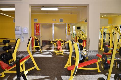 An Exercise Room With Yellow And Red Equipment