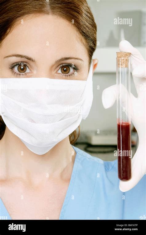 Female Lab Technician Holding Blood Sample In A Test Tube Stock Photo