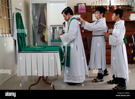Catholic Priest In Sacristy With Altar Boys Chau Doc Church Vietnam