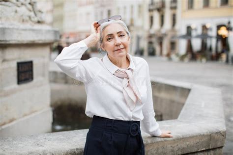 Elegant Senior Woman With Grey Hair Posing On Street Stock Image