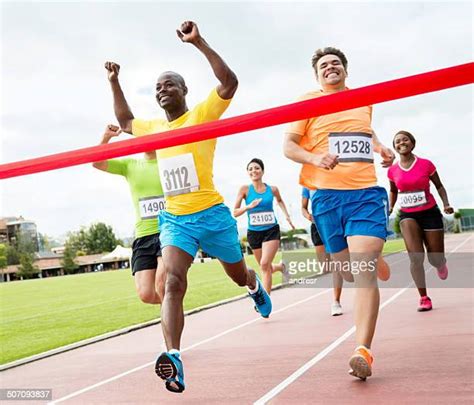 Runner Crossing Finish Line Photos And Premium High Res Pictures