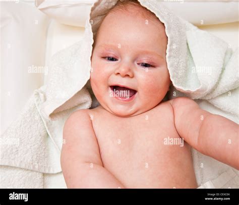 Infant Creaming Face On White Towel Stock Photo Alamy