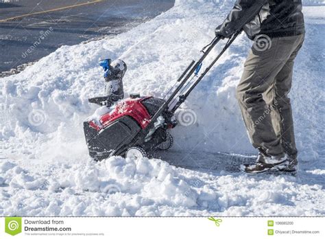 Man Removing Snow With A Snowblower On A Sunny Day Stock Photo Image