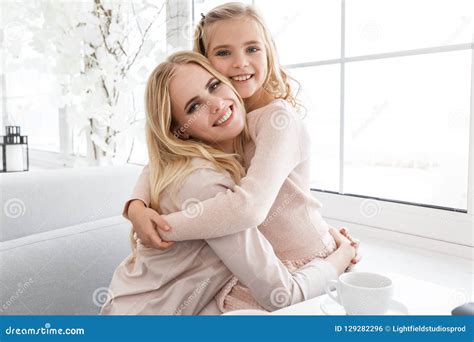 Mother And Daughter Embracing And Looking Stock Photo Image Of