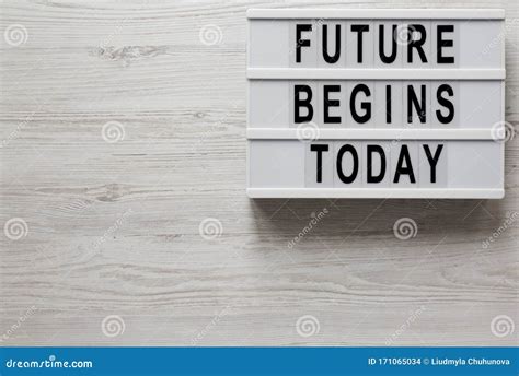 Future Begins Today Words On A Lightbox On A White Wooden Surface