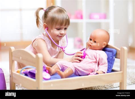 Kid Playing A Doctor With Doll Stock Photo Alamy