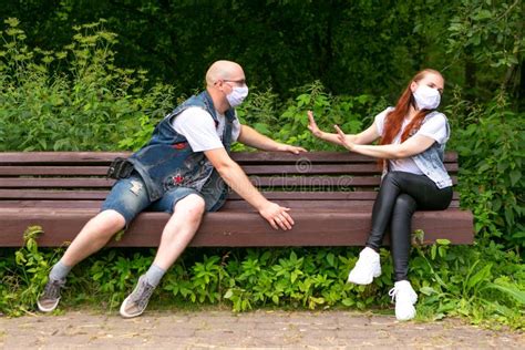 Couple Wearing Surgical Masks On A Date In The Park Stock Image