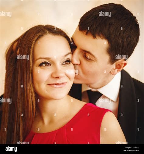 Close Up Portrait Of Young Pretty Stylish Couple Man Kissing His