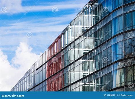 Modern Office Building With Glass Windows Against Blue Sky For Business