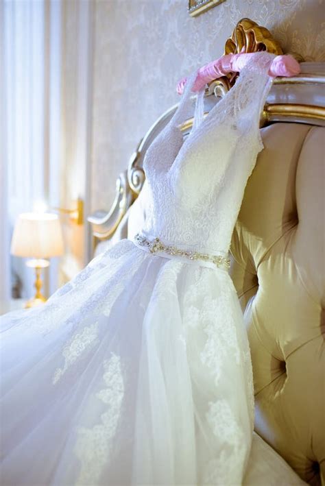 Beautiful White Wedding Dress For Bride Indoors On The Bed Stock Image