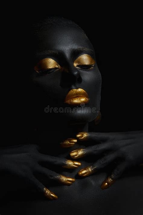 Beauty Woman Painted In Black Skin Color Body Art Gold Makeup Lips Eyelids Fingertips Nails In