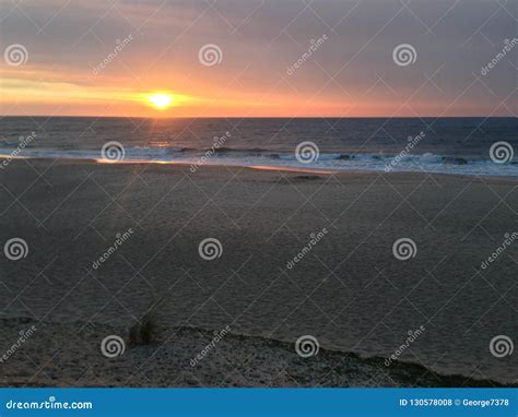 Sunset Over Sandy Beach With Calm Ocean Stock Photo Image Of Smooth