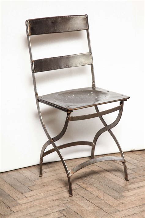 The chairs come with a custom cushion made with a coordinating black and white. French Folding Bistro Chairs at 1stdibs