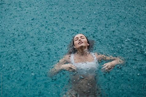 Woman In A Pool Swimming In The Rain Stocksy United Pool Photography