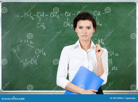 Serious Teacher Stands At The Blackboard Stock Photo Image Of