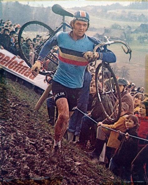 An Old Photo Of A Man On A Bike In The Mud With Other People Watching