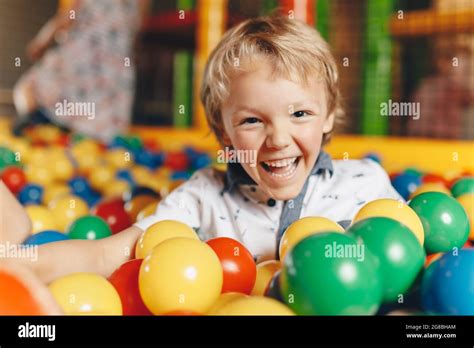 Happy Little Kid Boy Playing At Balls Pool Playground Happy Kid