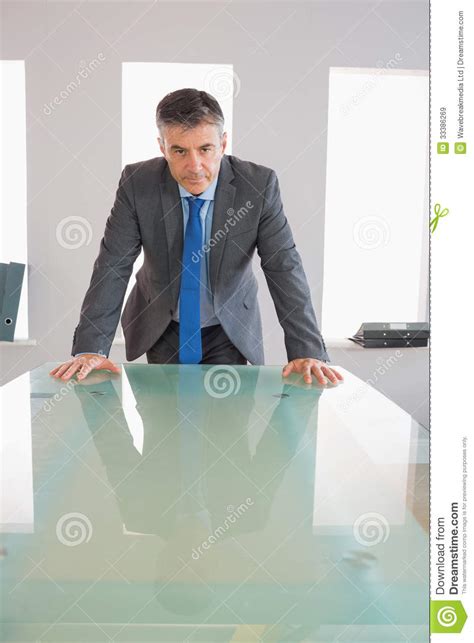 Serious Businessman Standing In Front Of A Desk Stock Image Image Of