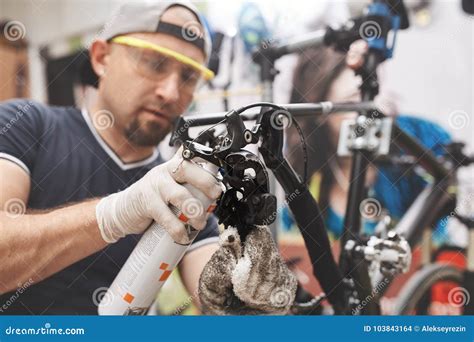 Bicycle Mechanic In A Workshop In The Repair Process Stock Photo