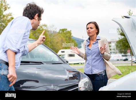Woman Driver And Angry Man Arguing About The Damage Of The Car Stock