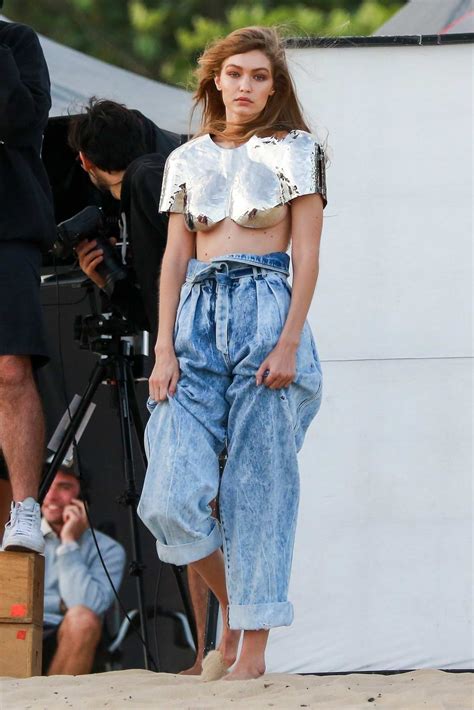 Gigi Hadid Poses In A Metallic Crop Top And Loose Fitting Jeans During A Photoshoot At The Beach