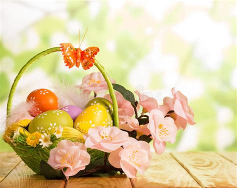Easter Eggs In Basket Butterfly And Flowers On Abstract Green Stock