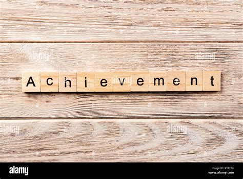 Achievement Word Written On Wood Block Achievement Text On Table