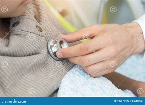 Doctor Checking Patient Heart Beat With Stethoscope Physical Ex Stock
