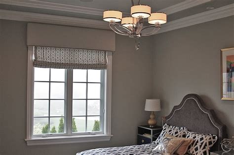 Roman Shades With Elegant Trimmed Cornice In The Bedroom