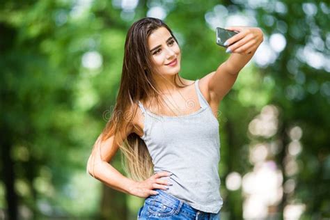 Outdoor Portrait Of Beautiful Girl Taking A Selfie With Mobile Phone Stock Image Image Of