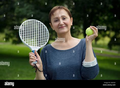 Woman Playing Tennis Portrait Of Active Middle Aged Woman Holding A