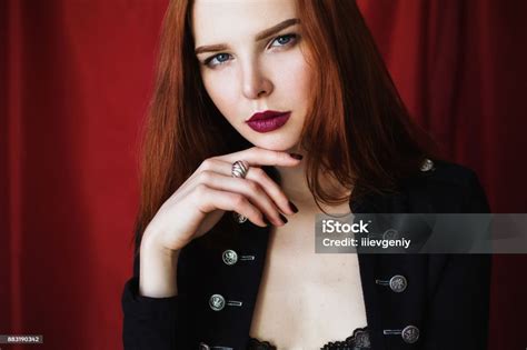 Beautiful Redhaired Girl In Black Unbuttoned Jacket With Red Lips On