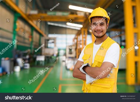 Waist Up Portrait Of Smiling Handsome Asian Factory Worker With Safety