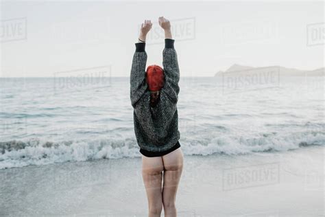 Back View Of Babe Woman With Naked Buttocks Raising Hands And Enjoying Freedom While Standing