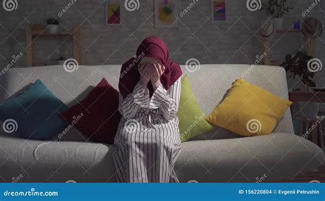 Young Muslim Woman In Depression Crying Sitting On The Couch In The Living Room Stock Footage