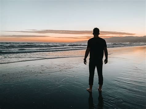 Man Standing At The Beach During Sunset Photo Free Person Image On