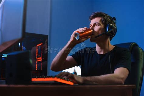 Gamer Drinking Energy Drink To Be Focused On Online Computer Game At