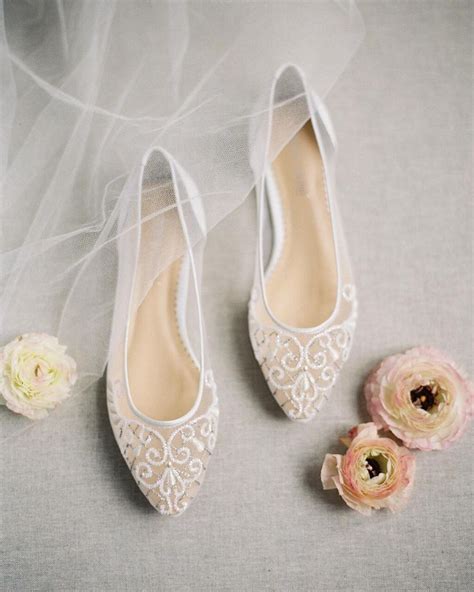 Wedding Shoes With Veil And Flowers On The Floor
