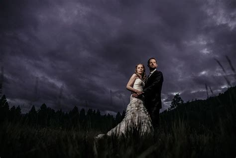 Dramatic Night Time Portrait Of Bride And Groom On Their Wedding Day At