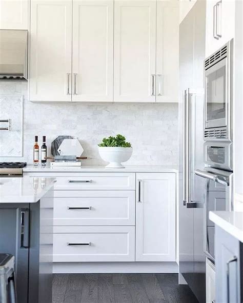 White kitchen cabinets contrasted with oil rubbed bronze pulls are fixed against a white tongue and groove backsplash over blue lower cabinets finished with. 12 Popular Hardware Ideas for Shaker Cabinets | White shaker kitchen, White shaker kitchen ...