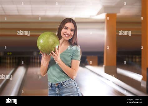 Young Woman With Ball In Bowling Club Stock Photo Alamy