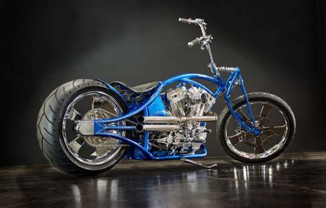 A Blue And Silver Motorcycle Parked On Top Of A Wooden Floor