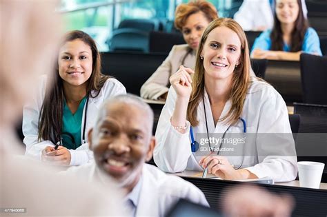 Female Doctor Asking Question During Healthcare Seminar At Hospital