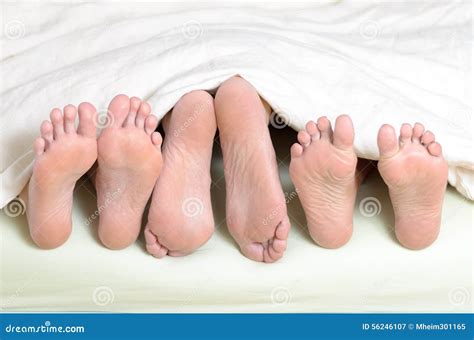 Three Pairs Of Feet In Bed Stock Image Image Of Menage