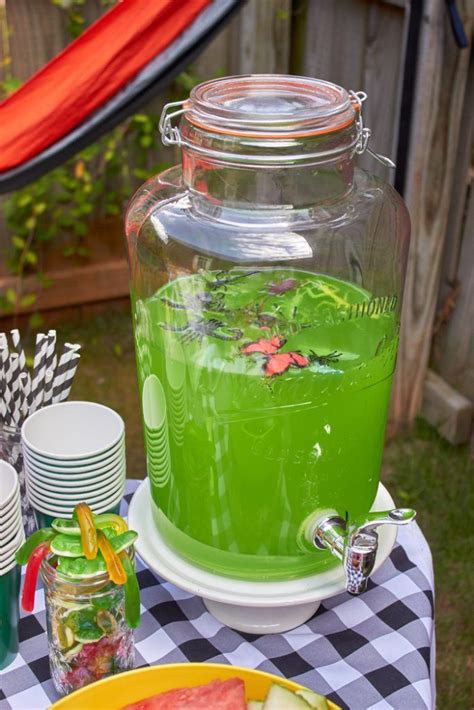 A Table Topped With Watermelon Juice And Plates Filled With Food Next